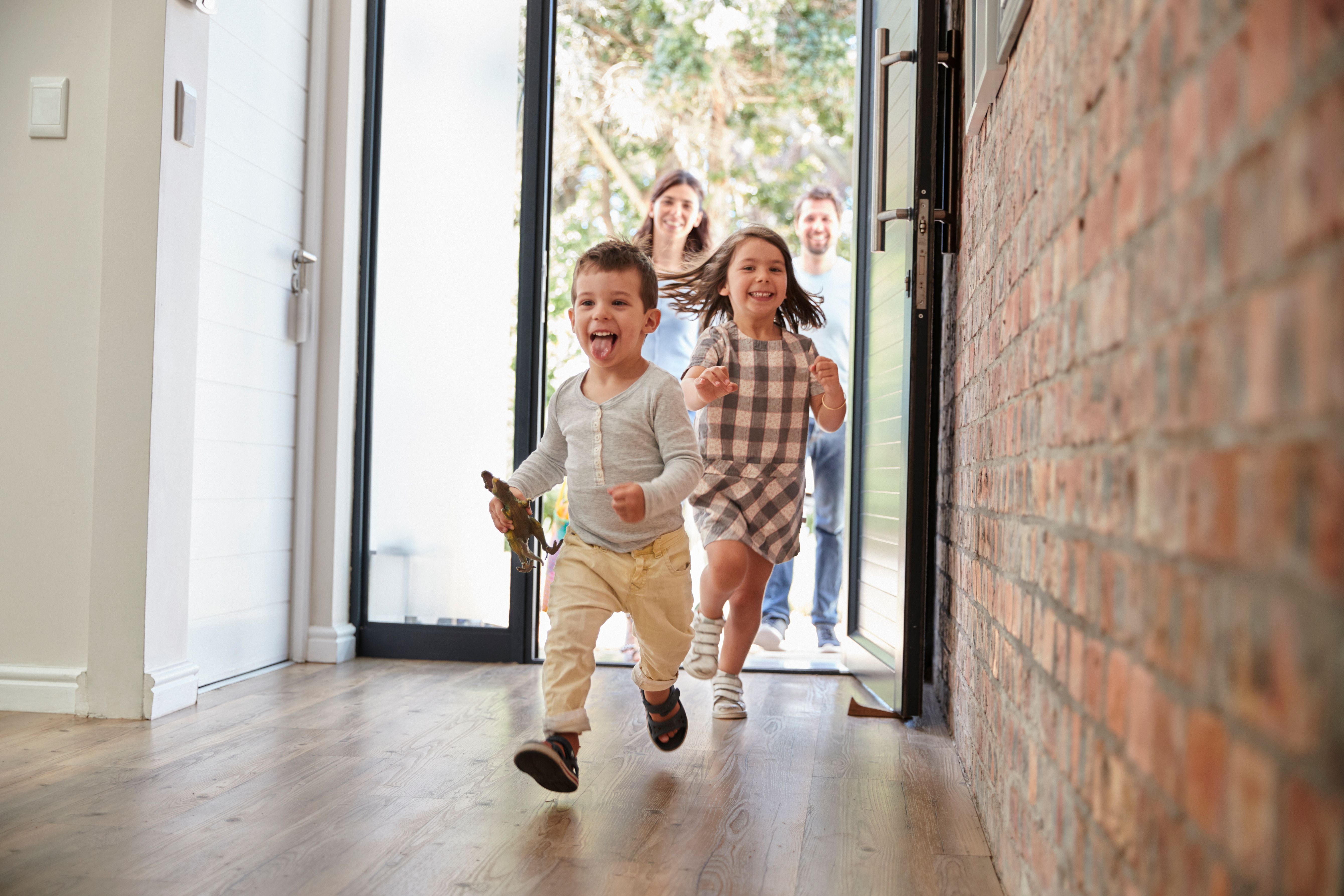 Children running into a warm home